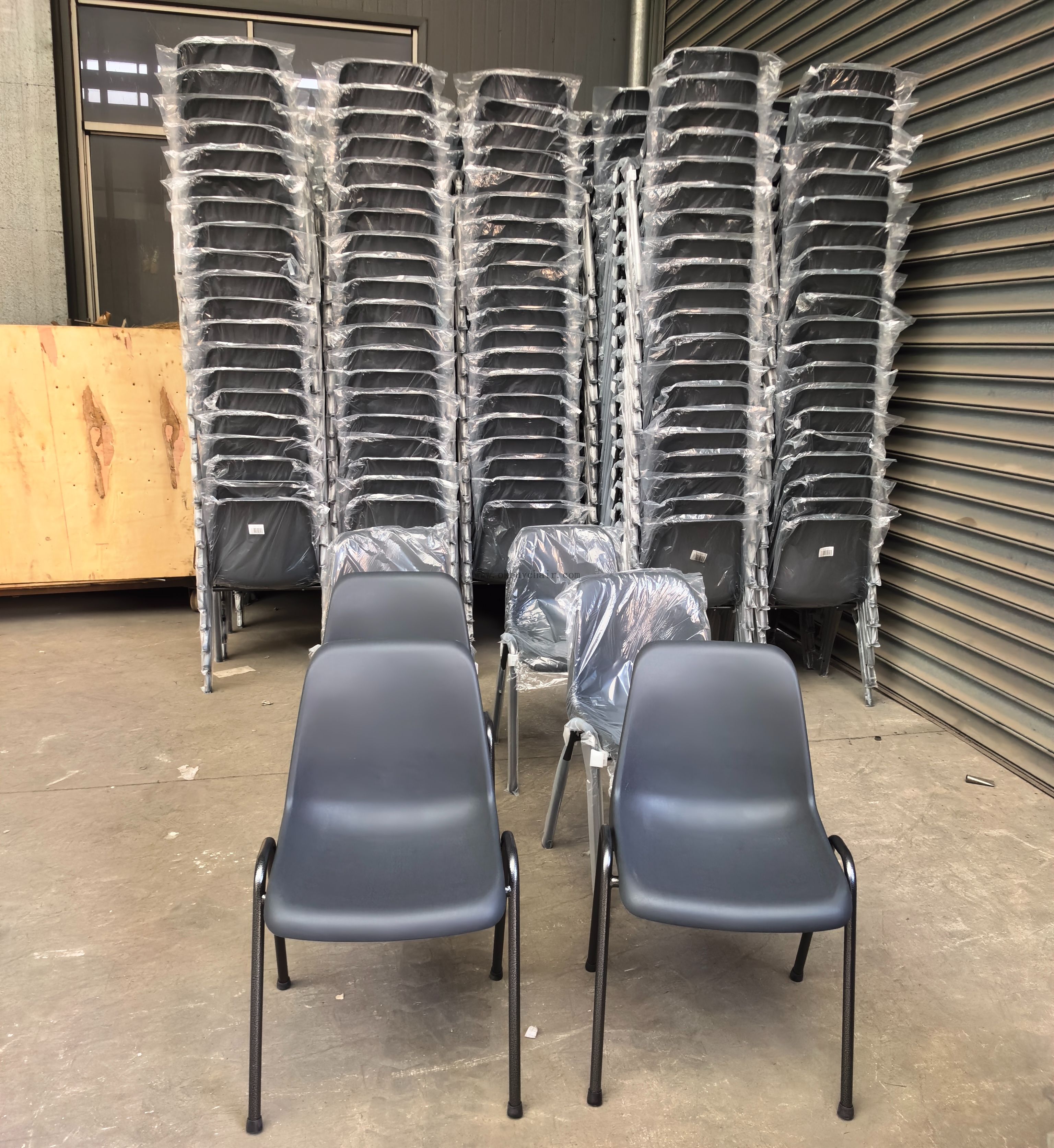 Front view of the modern black plastic chair highlighting the silver vein powder-coated steel legs