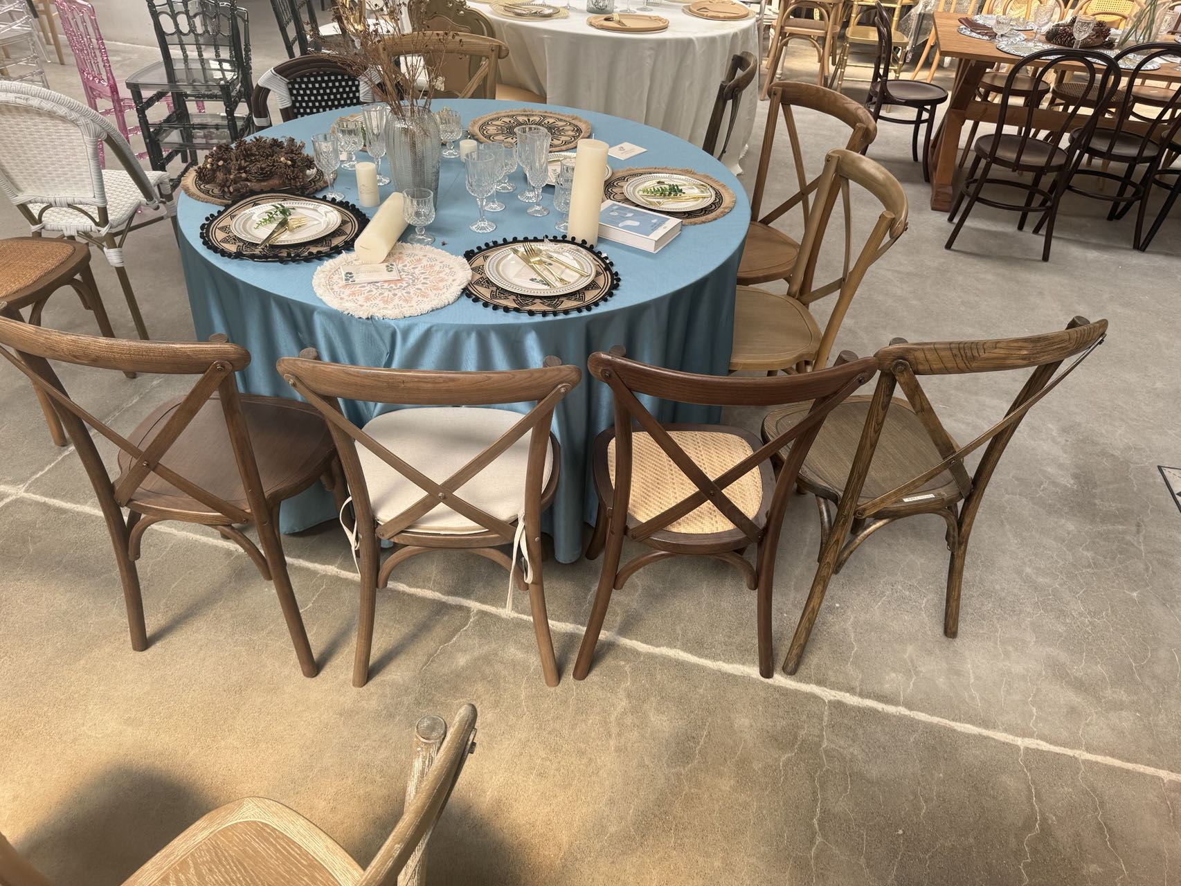 Stackable solid wood cross back event chairs in a commercial setting
